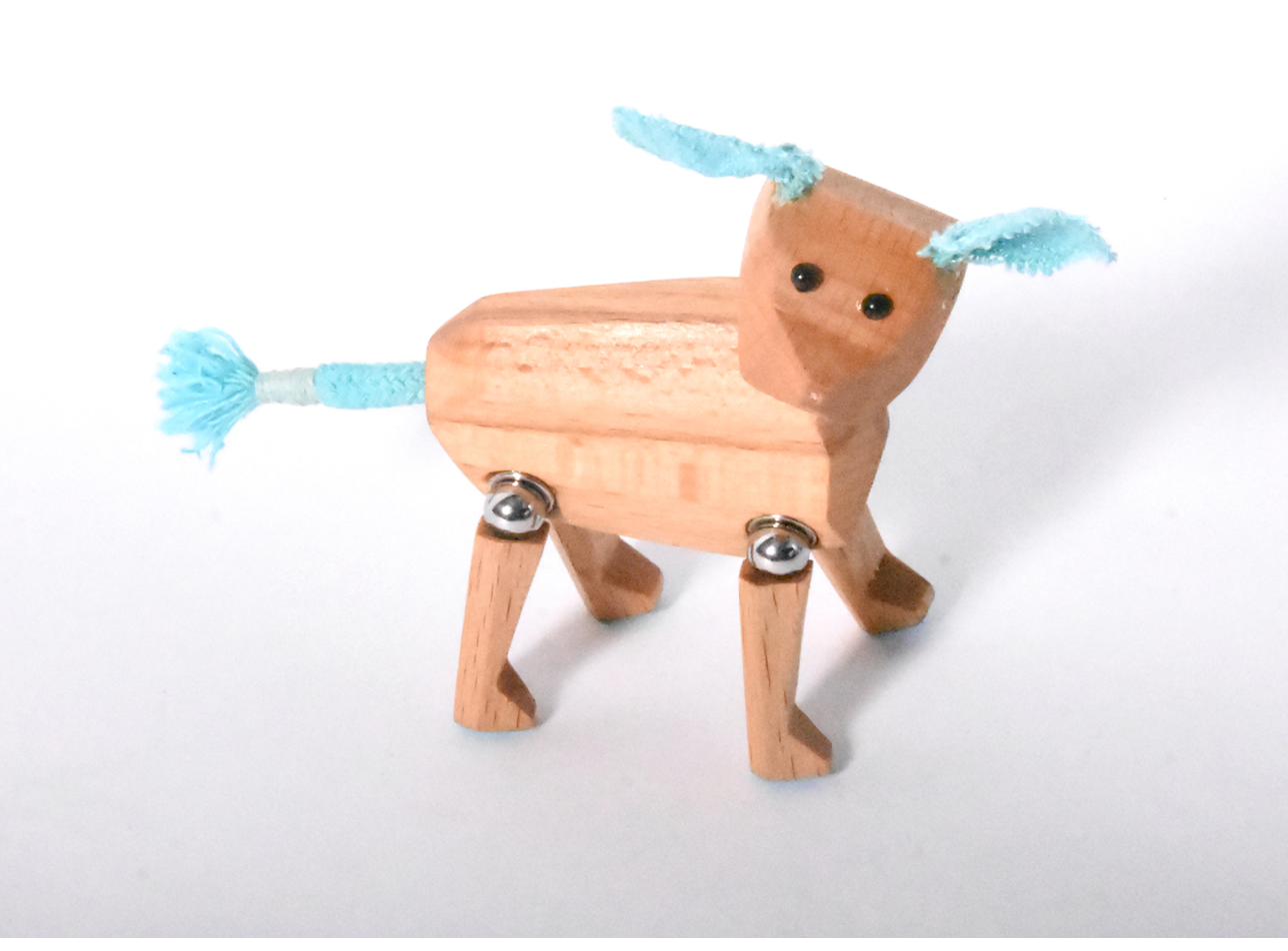 Wooden dog with blue ears and tail