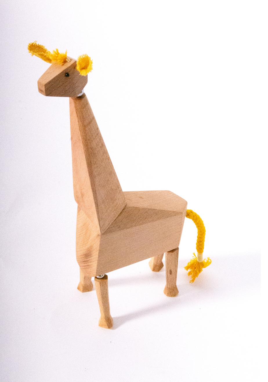 Tall wooden giraffe with yellow yarn mane and tail