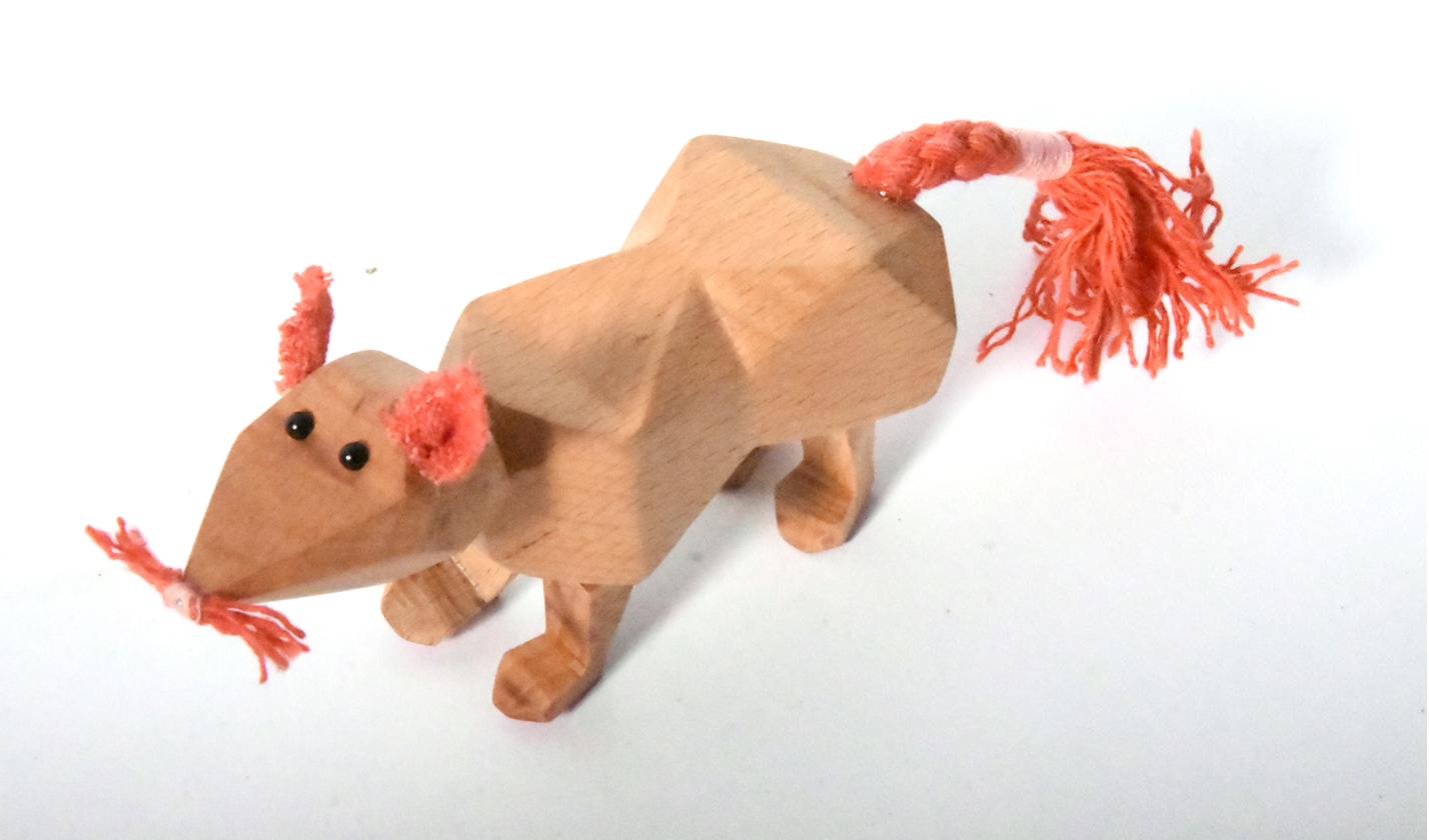 Wooden fox in low stance with coral tail